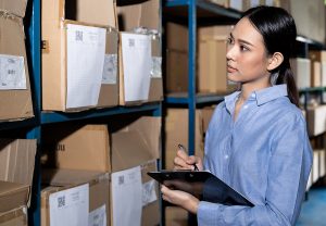Businesswoman doing an inventory in a 3PL Warehouse